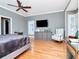 Primary bedroom with hardwood floors, ceiling fan, and natural lighting at 1403 W Watrous Ave, Tampa, FL 33606