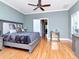 Primary bedroom with hardwood floors, ceiling fan, and plenty of natural light at 1403 W Watrous Ave, Tampa, FL 33606