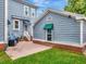 Home exterior features brick and blue siding plus a delightful patio area at 1403 W Watrous Ave, Tampa, FL 33606
