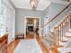 Elegant foyer features hardwood floors, staircase, and a view into a living room with fireplace at 1403 W Watrous Ave, Tampa, FL 33606