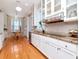 Well-lit kitchen with granite countertops, white cabinetry, and stainless steel appliances at 1403 W Watrous Ave, Tampa, FL 33606