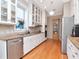 Bright kitchen featuring stainless steel appliances, white cabinets, and stylish countertops at 1403 W Watrous Ave, Tampa, FL 33606