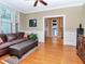 Cozy living room with a comfortable brown leather sofa and view into the bright and airy kitchen at 1403 W Watrous Ave, Tampa, FL 33606