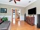 Comfortable living room with a TV and cabinet on the hardwood floor overlooking the kitchen at 1403 W Watrous Ave, Tampa, FL 33606