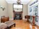 Cozy living room with fireplace, hardwood floors, and ample natural light at 1403 W Watrous Ave, Tampa, FL 33606