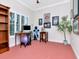 Home office with built-in shelving, large window, and sports memorabilia creates an inspiring work space at 1403 W Watrous Ave, Tampa, FL 33606