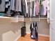 Bright walk-in closet with luggage and garment hanging features, and a door exiting the space at 1403 W Watrous Ave, Tampa, FL 33606