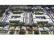 Wide aerial shot of two apartment complexes featuring central pools, lush landscaping, and dedicated parking spaces at 1706 Belleair Forest Dr # 336, Belleair, FL 33756