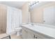 Clean bathroom featuring a shower with a curtain, toilet, and vanity with a large mirror at 1706 Belleair Forest Dr # 336, Belleair, FL 33756