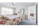 Cozy bedroom featuring a comfortable bed and a bright entryway at 1706 Belleair Forest Dr # 336, Belleair, FL 33756