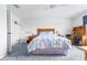 Bedroom with wooden furniture, blue carpet, ceiling fan and a desk near a window at 1706 Belleair Forest Dr # 336, Belleair, FL 33756