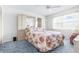 Bedroom featuring blue carpet, light walls, built in storage, and a large window at 1706 Belleair Forest Dr # 336, Belleair, FL 33756