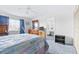Cozy bedroom with blue carpet, wooden dresser, bathroom entrance and a large window for natural light at 1706 Belleair Forest Dr # 336, Belleair, FL 33756
