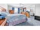 Bedroom featuring blue carpet, wooden furniture, a window with curtains, and ensuite bathroom at 1706 Belleair Forest Dr # 336, Belleair, FL 33756