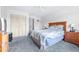 Bedroom with blue carpet, wooden furniture, ceiling fan, closet doors and a large bed at 1706 Belleair Forest Dr # 336, Belleair, FL 33756
