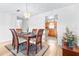 Elegant dining room with wood table, chandelier, and view into the kitchen at 1706 Belleair Forest Dr # 336, Belleair, FL 33756