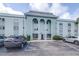 Beautiful exterior view of building with a parking lot in front at 1706 Belleair Forest Dr # 336, Belleair, FL 33756
