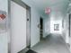 Hallway featuring an elevator and exit signs at 1706 Belleair Forest Dr # 336, Belleair, FL 33756