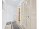 Bright hallway with tile flooring, closet doors, and an entryway leading to the kitchen at 1706 Belleair Forest Dr # 336, Belleair, FL 33756