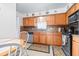 Bright eat-in kitchen featuring wood cabinets, neutral countertops and stainless steel appliances at 1706 Belleair Forest Dr # 336, Belleair, FL 33756