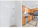 Traditional-style kitchen featuring oak cabinetry, neutral countertops, and stainless steel appliances at 1706 Belleair Forest Dr # 336, Belleair, FL 33756