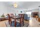 Open-plan dining and living area featuring wood floors, ceiling fan, and lots of natural light at 1706 Belleair Forest Dr # 336, Belleair, FL 33756