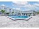 Community pool surrounded by lounge chairs and lush landscaping, perfect for relaxation at 1706 Belleair Forest Dr # 336, Belleair, FL 33756