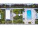 Overhead image of a community swimming pool, bordered by lounge chairs and surrounded by meticulously maintained greenery at 1706 Belleair Forest Dr # 336, Belleair, FL 33756