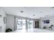 Bright recreation room with plank flooring, slider to pool area, and television for resident enjoyment at 1706 Belleair Forest Dr # 336, Belleair, FL 33756