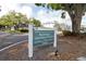 Community sign with address and entrance information, surrounded by manicured landscaping at 1706 Belleair Forest Dr # 336, Belleair, FL 33756