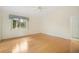 A bright bedroom featuring wood floors, a ceiling fan, and a double-door closet at 1805 Granville Ln, Sun City Center, FL 33573