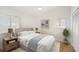 A bright bedroom with a ceiling fan, wood floors, neutral walls, and a queen-sized bed at 1805 Granville Ln, Sun City Center, FL 33573