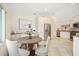 Bright kitchen featuring stainless steel appliances, white cabinetry and a dining area at 1805 Granville Ln, Sun City Center, FL 33573