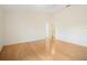 A large main bedroom with wood floors, a ceiling fan, and a walk-in closet at 1805 Granville Ln, Sun City Center, FL 33573