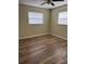 Bedroom with natural light, new floors, and modern ceiling fan at 1809 Driftwood N Cir, Oldsmar, FL 34677