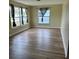 Bright living room with hardwood floors and large windows providing natural light at 1809 Driftwood N Cir, Oldsmar, FL 34677