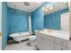Bathroom featuring a clawfoot tub and vintage-style fixtures with an accent wall at 18132 Oakdale Rd, Odessa, FL 33556