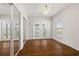 Primary bedroom featuring hardwood floors, mirrored closets, and a view of the water at 18132 Oakdale Rd, Odessa, FL 33556