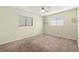 Neutral bedroom with carpeted floors, a ceiling fan, and two large windows for natural light at 18132 Oakdale Rd, Odessa, FL 33556