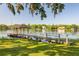 Picturesque lake view with a wooden dock and gazebo, surrounded by lush greenery and peaceful waters at 18132 Oakdale Rd, Odessa, FL 33556