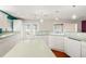 Large kitchen featuring white cabinets and countertop, with views to outside at 18132 Oakdale Rd, Odessa, FL 33556