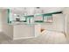 Kitchen area with white cabinets, a breakfast bar, and modern appliances at 18132 Oakdale Rd, Odessa, FL 33556
