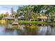 Beautiful lake view featuring a boat dock and a glimpse of the property from the water at 18132 Oakdale Rd, Odessa, FL 33556