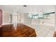 Living room and kitchen area with ceramic tile and hardwood flooring at 18132 Oakdale Rd, Odessa, FL 33556