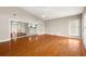 Open floor plan with hardwood floors leading to a dining area and adjacent kitchen at 18132 Oakdale Rd, Odessa, FL 33556