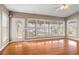 Bright living room featuring hardwood floors, large windows, and a view of the water at 18132 Oakdale Rd, Odessa, FL 33556