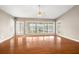 Spacious living room boasts hardwood floors, neutral tones, and large windows showcasing lake views at 18132 Oakdale Rd, Odessa, FL 33556