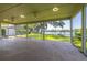 Large screened porch with views of the lush lawn, lake, and gazebo on the water at 18132 Oakdale Rd, Odessa, FL 33556