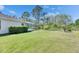 Lush backyard with a screened pool enclosure and ample green space at 21744 Waverly Shores Ln, Land O Lakes, FL 34637
