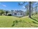 Manicured backyard featuring a screened-in pool and lush green lawn at 21744 Waverly Shores Ln, Land O Lakes, FL 34637